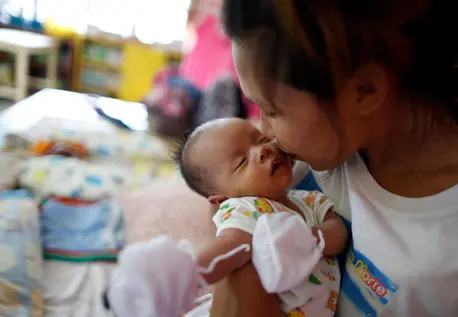 Fleeing Super Typhoon Mangkhut, Rogeline, 22, kisses her 1-month-old daughter, Kristan, at the school turned evacuation shelter in Ilocos Norte Province in northern Luzon, the Philippines, on September 14, 2018. unicef, super typhoon mangkhut, philippines, disaster preparedness, emergency preparedness, emergency relief