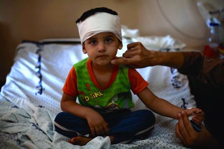 On 25 July 2014 in the State of Palestine, Mohammed Fakhri Naim, 3, sits on a cot in Al-Shifa Hospital in Gaza. © UNICEF/NYHQ2014-1012/d’Aki