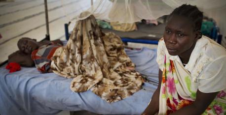 A displaced woman sits at her daughter’s bedside in a UNICEF-supported emergency medical center in Malakal, South Sudan.