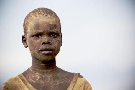 Mathiang, 10, stands at a food distribution site in the town of Mingkaman, South Sudan.