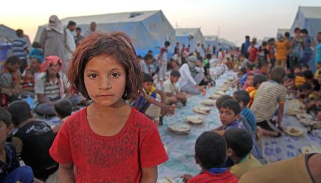 A girl is among displaced children and adults who have gathered for ‘Iftar’ in the Khazar transit camp in the northern-eastern city of Erbil, capital of Kurdistan Region. 