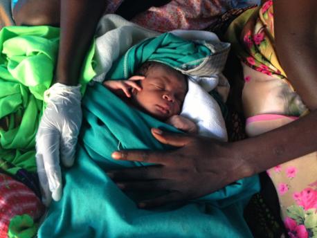 Only a few hours old, this young boy was born inside the Mingkaman internally displaced persons site in South Sudan. © UNICEF South Sudan/2014/KentPage