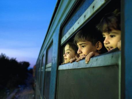 Three Children Looking out a Window
