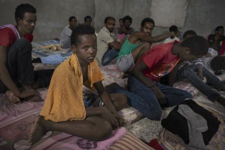 Sagga, 12 years old, and other inmates at a detention camp for migrants in Zawya, Libya.