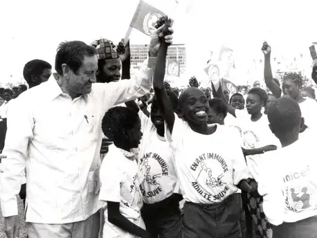 Former UNICEF Executive Director James P. Grant, in 1988, marks Senegal's achievement of the Africa child immunization target of 75 per cent