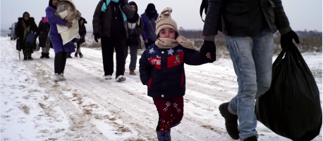 Migrant families trek through the snow in Syria.