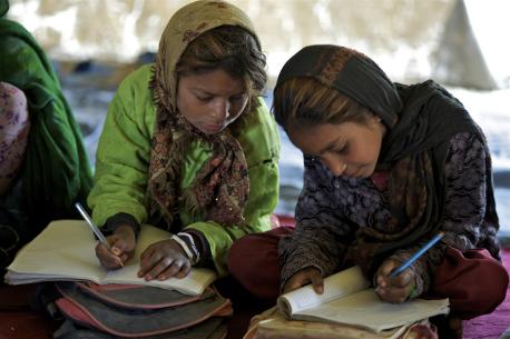  Holia (8 years old) from Jogi ethnic group, writes Dari in her textbook at UNICEF supported Mowla Ali community based school (CBS) in Khurasan neighbourhood in the city of Mazar in northern Afghanistan.