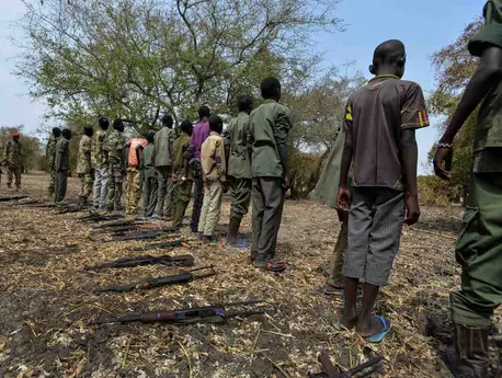 Children surrender their weapons during a ceremony formalizing their release from the SSDA Cobra Faction armed group, in Pibor, South Sudan.