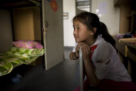 Girl Sitting on the Edge of Bed
