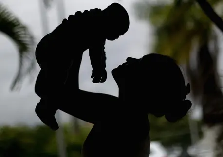 Alice,15 years old, holds her a 4-month old baby born with microcephaly in Recife. She was infected with the Zika virus when she was pregnant.