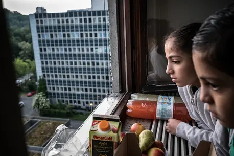 Two Children Looking Out Window