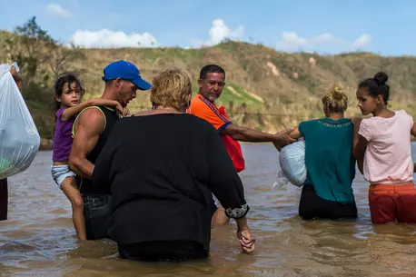 People Wading Through Water