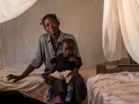 Woman Sitting on Bed With Child