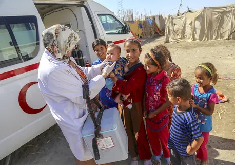 Children Gather Around Aid