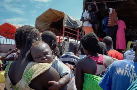 South Sudanese refugees board a truck to be taken to a new settlement at Imvepi Reception Center in Arua district of Uganda.