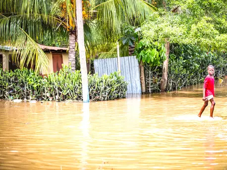 On Sept 8 2017, a child wades through flood waters outside the town of Ouanaminthe, Haiti.