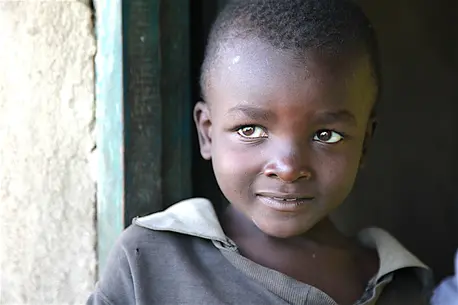 Child Smiling in a Doorway