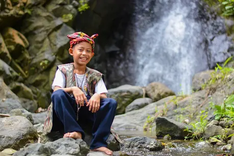 Child Next to a Waterfall