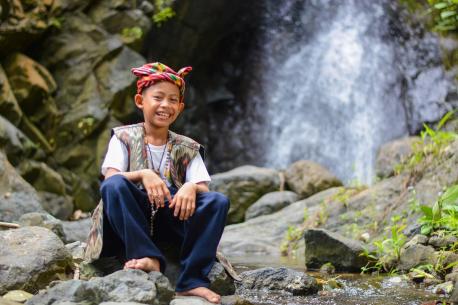 Child Next to a Waterfall