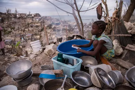 Child surrounded by Pots and Bowls