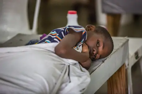 Child Laying Down with Blanket
