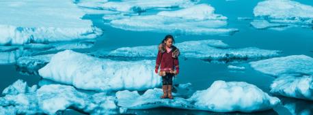 Iñupiat girl Amaia, 11, standing on a ice floe on a shore of the Arctic Ocean in Barrow, Alaska in the United States of America. The anomalous melting of the Arctic ice is one of the many effects of global warming.