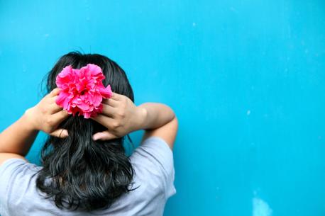 Girl Facing a Wall With Hands Behind Head