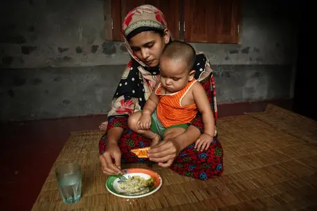 Mother Feeding Child