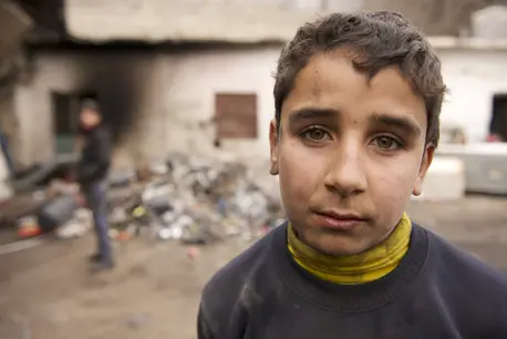 Child in front of rubble