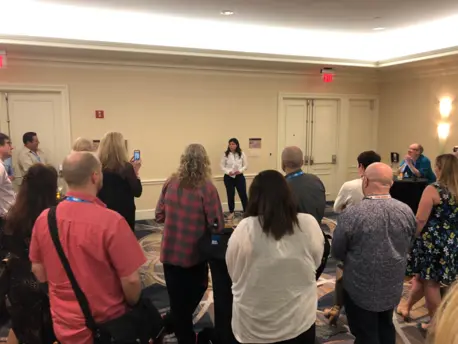 Person Speaking to a Room Full of Onlookers