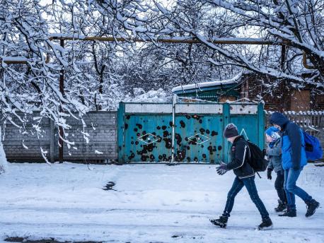 Twelve-year-old Sasha, left, walks to school in the town of Avdivka, Donetsk Oblast, Ukraine, November 2017. Because of shelling and lack of heat, his school is open only three days a week. 