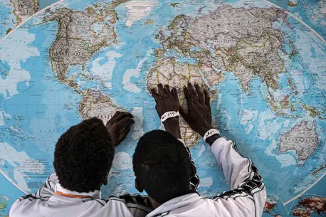Children Looking at World Map