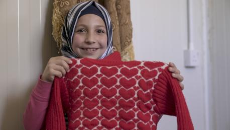 Lama, 9, a Syrian refugee living with her family in the Za'atari camp, was able to get this warm sweater thanks to UNICEF's winterization support program.