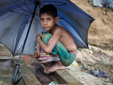 A girl in Balukhali seeks shelter from the monsoon rains in Balukhali, part of the refugee camp sheltering over 800,000 Rohingya refugees in Cox's Bazar, Bangladesh. unicef, rohingya, rohingya refugees, bangladesh, monsoon rains, monsoon season