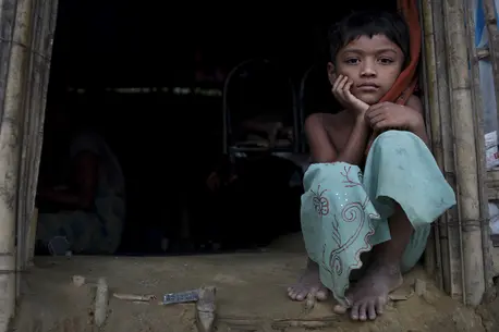Murium Begu, 7, sits by the entrance of her home in Chakmakul, a refugee camp sheltering over 800,000 Rohingya refugees, in Cox's Bazar, Bangladesh. Murium Begu, 7, sits by the entrance of her home in Chakmakul, a refugee camp sheltering over 800,000 Rohingya refugees, in Cox's Bazar, Bangladesh.