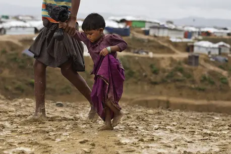 Adult and Child Walking Through Mud