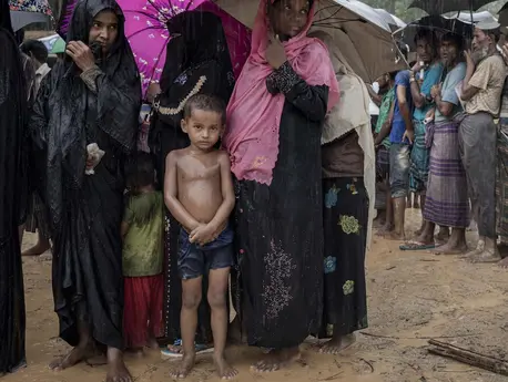 Sawkat Ullah, 6, is waiting in line for bamboo to reinforce the shelter they call home in a Rohingya refugee camp in Bangladesh. 
