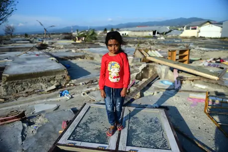 Marwah, 8, stands amid the ruins of her family's home, destroyed when a tsunami struck Sulawesi island, Indonesia on Sept. 28. Marwah, 8, stands amid the ruins of her family's home, destroyed when a tsunami struck Sulawesi island, Indonesia on Sept. 28.