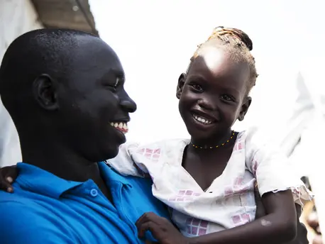 UNICEF caseworker Simon Char holds 5-year-old Nyajiper, who was separated from her parents for more than four years. UNICEF found her father, so the two can be reunited. UNICEF, South Sudan, family reunification