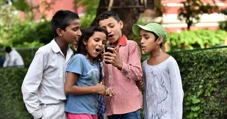 Four Children Looking at Phone