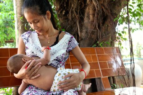 A mother in Cambodia breastfeeds her baby.