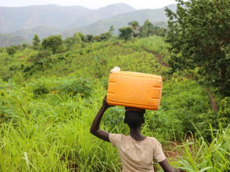 Liliane, 14, carries an empty container as she makes her way to collect safe drinking water in Mukerezi-Mpakaniro hill, Makamba Province, Burundi, January 2017.