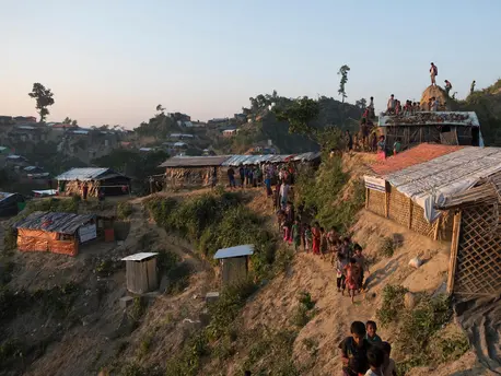 Rohingya refugee children walk along a narrow path hugging a steep slope at the Unchiprang spontaneous site, Cox's Bazar District, Bangladesh, January 2018. Rohingya refugee children walk along a narrow path hugging a steep slope at the Unchiprang spontaneous site, Cox's Bazar District, Bangladesh, January 2018.