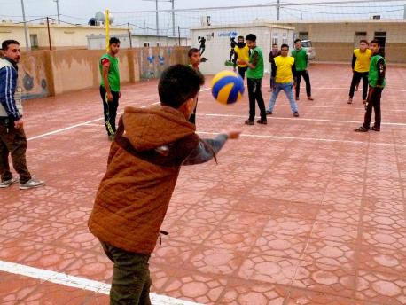 Friends play volleyball at Debaga camp in Iraq. UNICEF is working to provide counseling and education for young people affected by violence in Iraq.