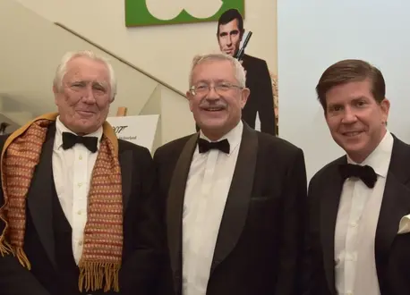Three Men in Suits Smile at the Camera
