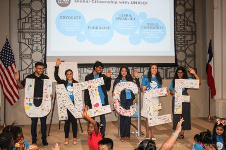 Children Stand on Stage with UNICEF Sign