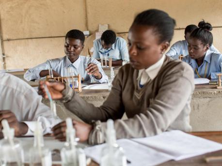 Adolescent girls conduct experiments during a chemistry at UNICEF-supported Kamulanga Secondary School in Lusaka, Zambia in 2016.