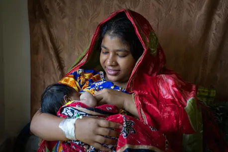 A mother breastfeeds her newborn baby at the maternity ward of a UNICEF-supported district hospital in Bangladesh. A mother breastfeeds her newborn baby at the maternity ward of a UNICEF-supported district hospital in Bangladesh.