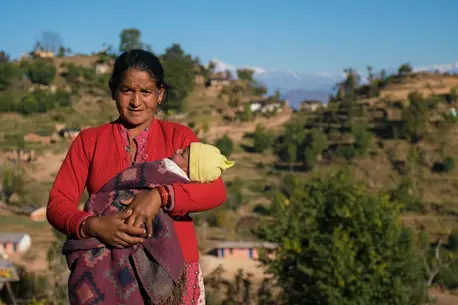 Janaki Odh with her 16-day old baby girl Nisha in Joshibunga, a village in Baitadi District, far western Nepal. Sixteen days before we captured this story, she gave birth to a baby girl, Nisha. She had a home delivery, but halfway through she noticed that Janaki Odh with her 16-day old baby girl Nisha in Joshibunga, a village in Baitadi District, far western Nepal. Sixteen days before we captured this story, she gave birth to a baby girl, Nisha. She had a home delivery, but halfway through she noticed that