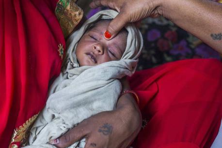 A UNICEF-IKEA Foundation supported health care worker makes a home visit to see how this newborn from a village in northern India is doing. After a safe delivery, a newborn requires tender care to ensure safe passage through the first thousand days life. 